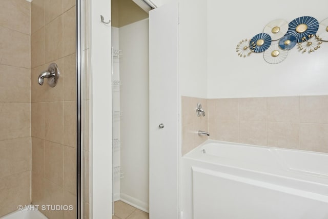 bathroom featuring tile patterned floors and independent shower and bath