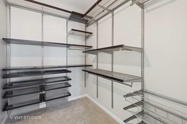 walk in closet with carpet