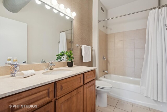 full bathroom with vanity, tile patterned flooring, toilet, and shower / tub combo with curtain