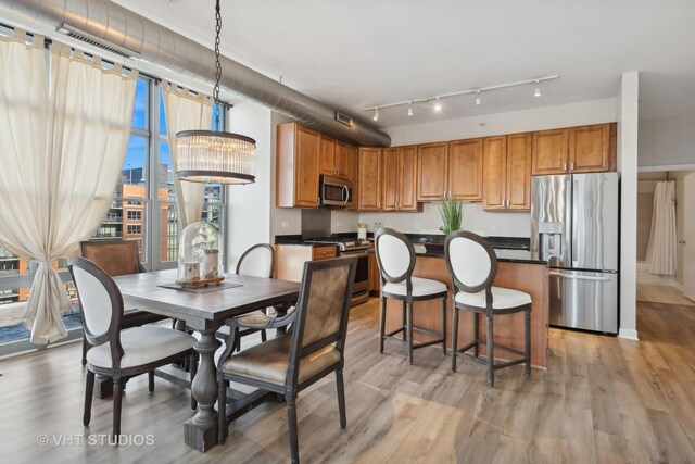 kitchen featuring a kitchen island, light wood-type flooring, and appliances with stainless steel finishes