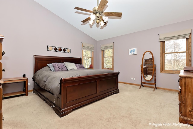 carpeted bedroom featuring lofted ceiling, multiple windows, and ceiling fan