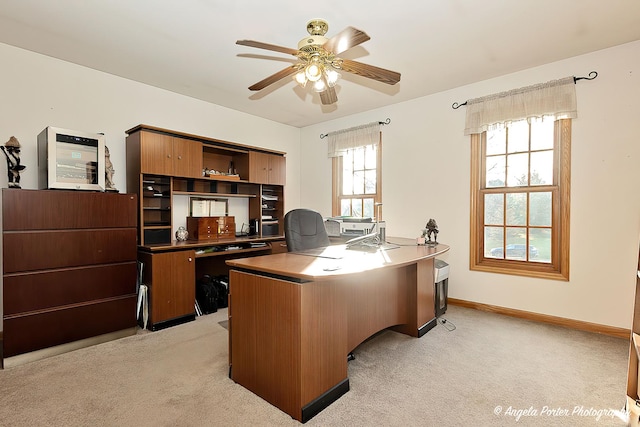 home office featuring ceiling fan and light colored carpet