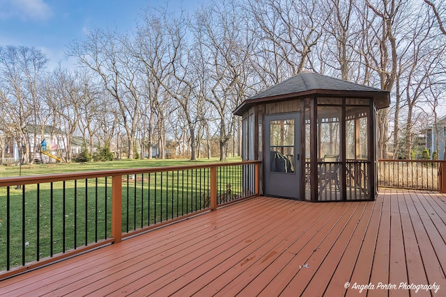 wooden deck featuring a yard