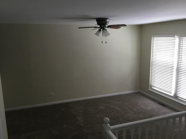 unfurnished room featuring ceiling fan and carpet