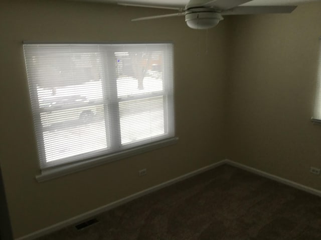 unfurnished room with ceiling fan, carpet floors, and plenty of natural light