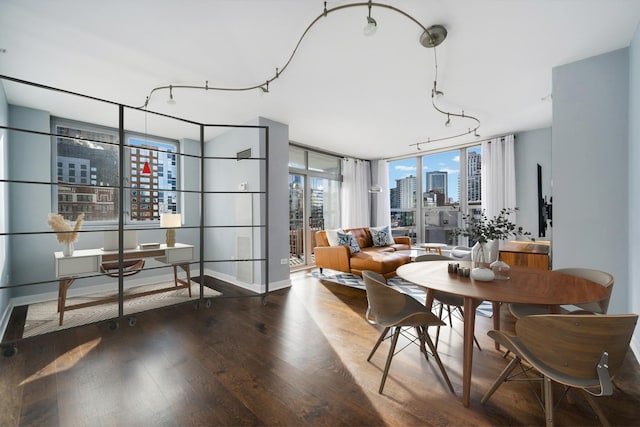 dining room with hardwood / wood-style floors and a wall of windows