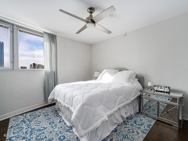 bedroom featuring ceiling fan and dark hardwood / wood-style flooring