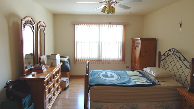 bedroom with light wood-style floors and ceiling fan