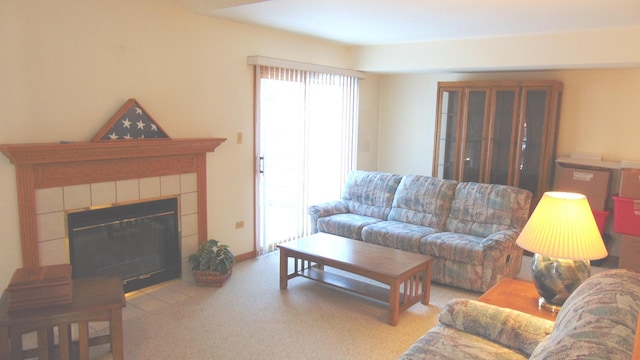 living room featuring light carpet and a tiled fireplace