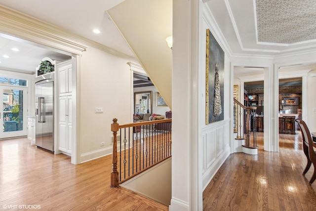 hall featuring hardwood / wood-style flooring and crown molding