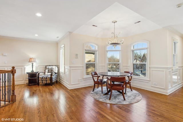 dining room with an inviting chandelier, dark hardwood / wood-style floors, and crown molding