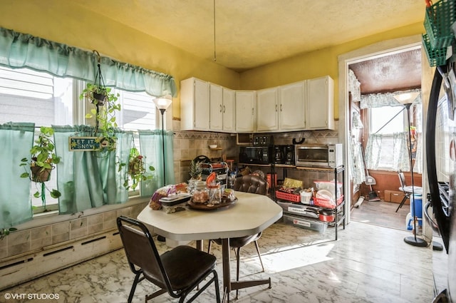 kitchen featuring white cabinetry and decorative backsplash