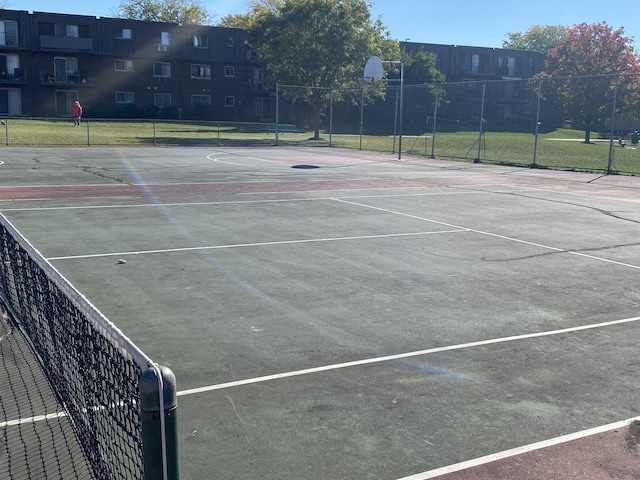 view of sport court with basketball court and a lawn