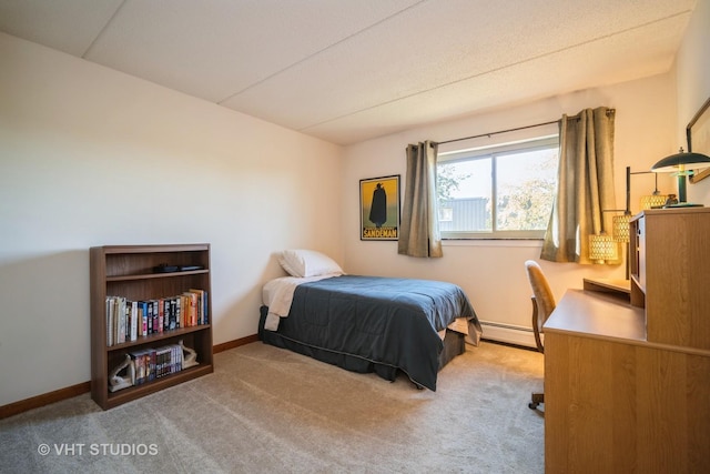 bedroom with light colored carpet and a baseboard radiator