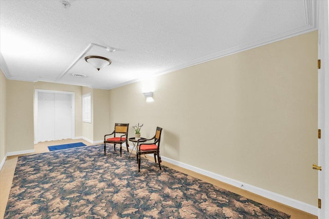 living area with crown molding and a textured ceiling