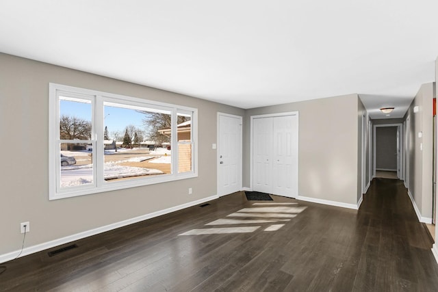 empty room featuring dark hardwood / wood-style flooring