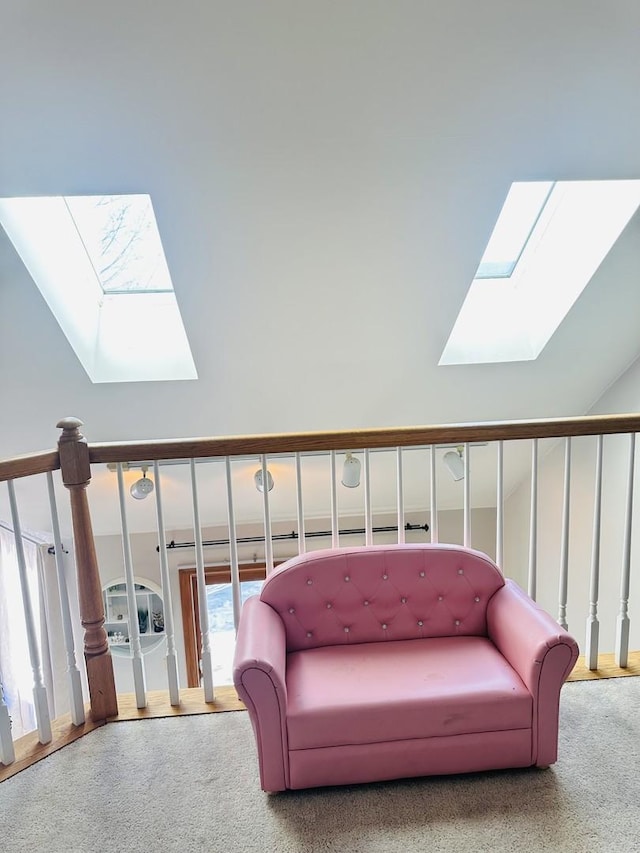 living area with light colored carpet and lofted ceiling with skylight