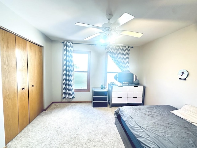 bedroom featuring a closet, ceiling fan, and light colored carpet