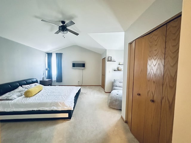 bedroom featuring lofted ceiling, a closet, ceiling fan, and light carpet