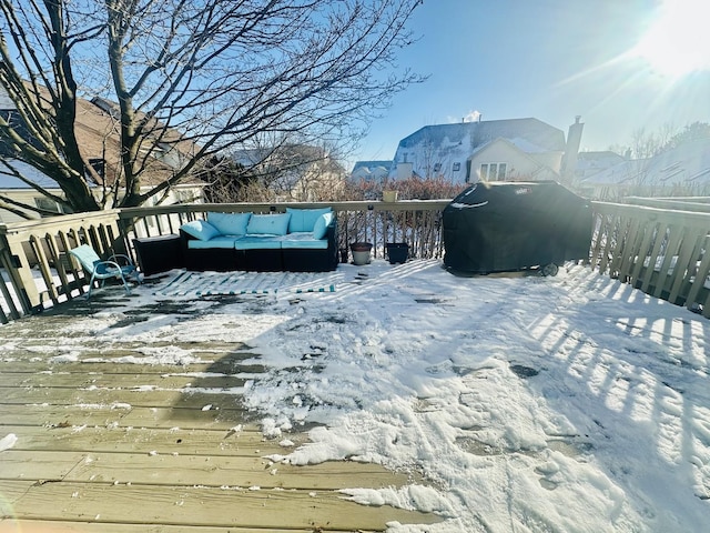 snow covered deck with outdoor lounge area and grilling area