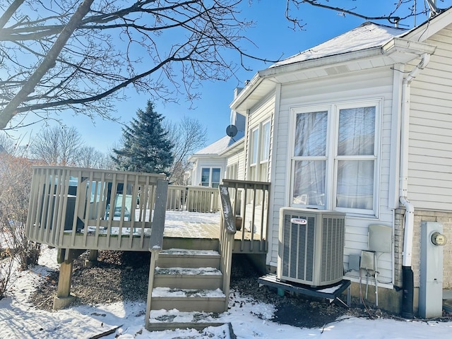 snow covered deck featuring cooling unit