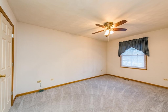 empty room featuring carpet floors and ceiling fan