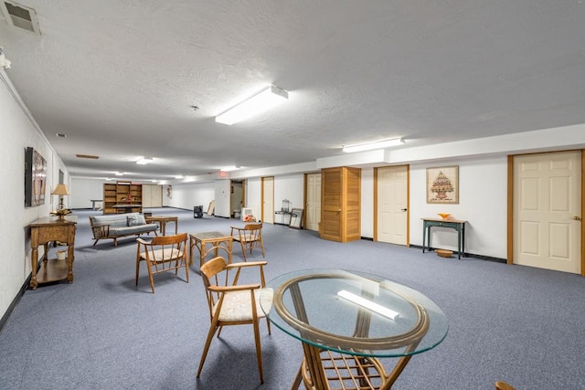 interior space featuring carpet floors and a textured ceiling