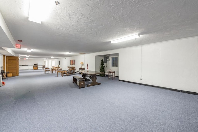 interior space featuring a textured ceiling and carpet flooring