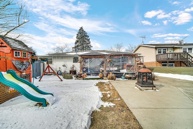 snow covered property with a playground and a gazebo