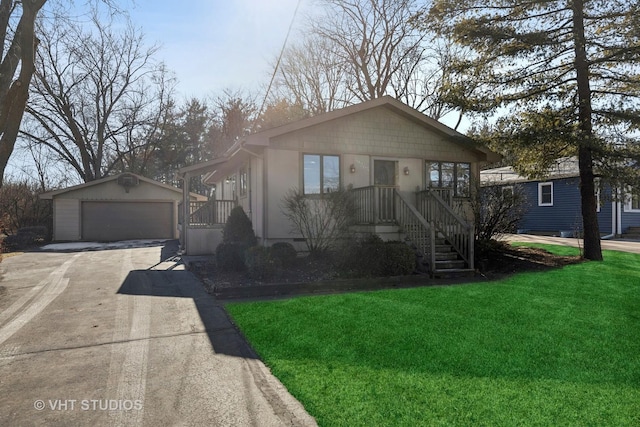 view of front of home with a garage, an outdoor structure, and a front lawn