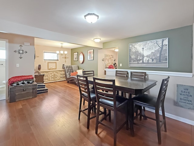 dining space featuring an inviting chandelier and wood-type flooring