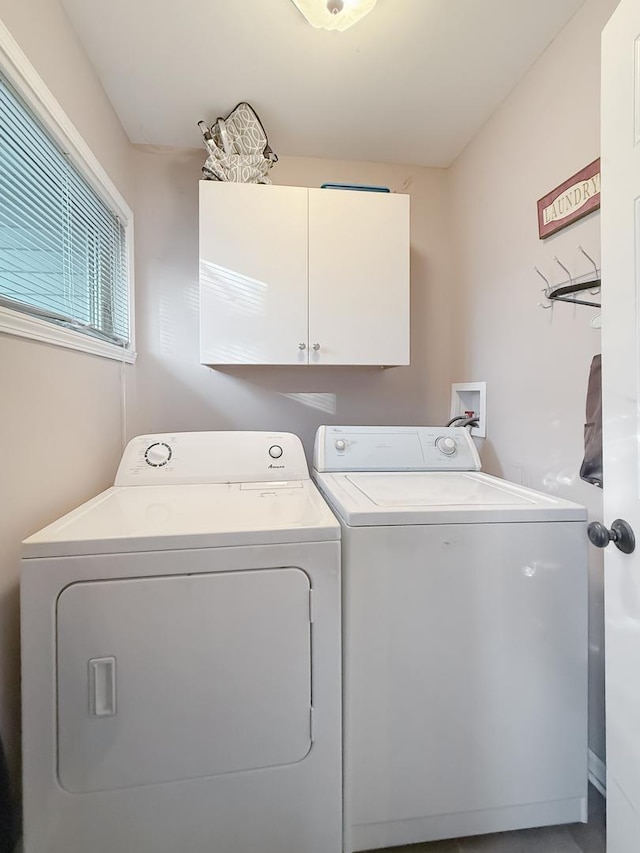 washroom with washing machine and dryer and cabinets