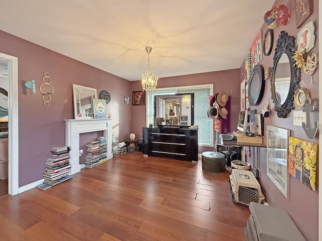 misc room with a chandelier and hardwood / wood-style flooring