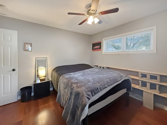 bedroom with ceiling fan and dark hardwood / wood-style flooring