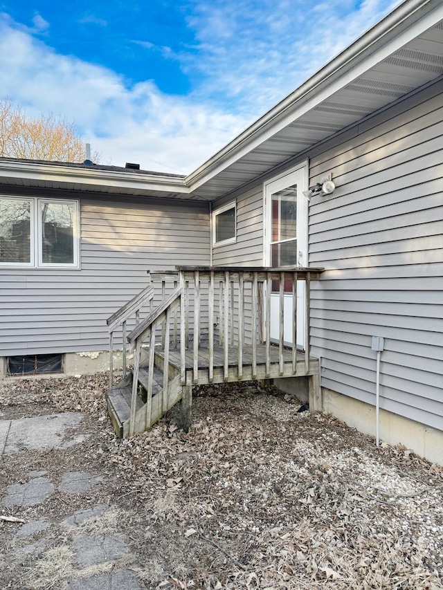 view of exterior entry with a deck