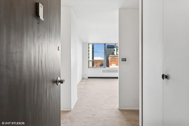 hall with light colored carpet