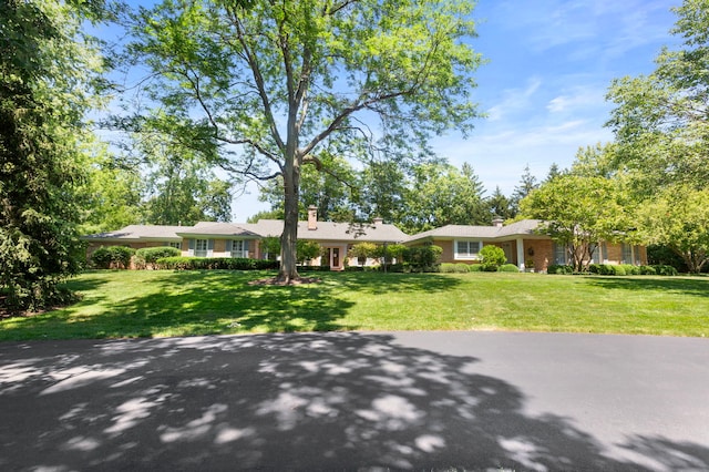 ranch-style home with a front lawn