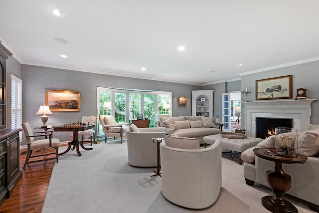 living room with dark wood finished floors, recessed lighting, a high end fireplace, and ornamental molding