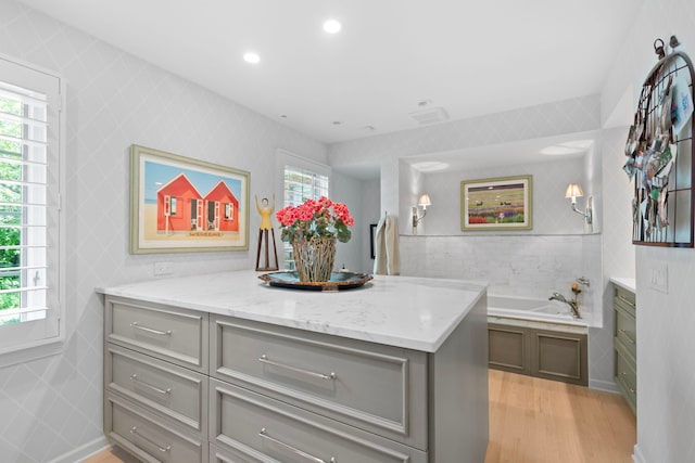 kitchen with tile walls, recessed lighting, light wood finished floors, and gray cabinetry