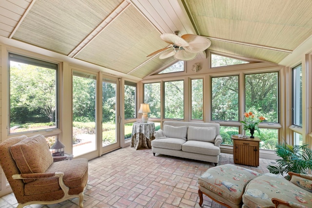 sunroom with lofted ceiling, wood ceiling, ceiling fan, and a healthy amount of sunlight