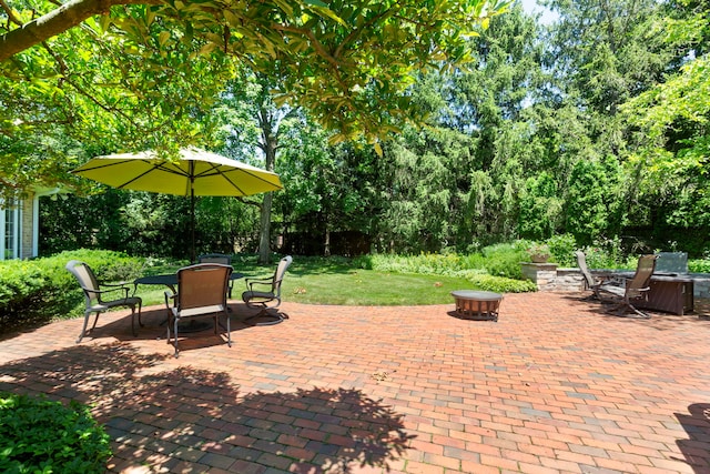 view of patio / terrace with outdoor dining area and a fire pit