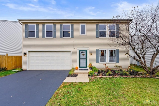 view of front of house featuring a front lawn and a garage