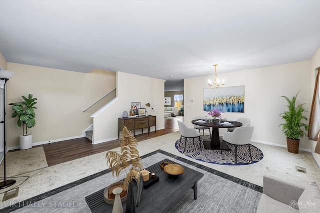 living room with an inviting chandelier and wood-type flooring