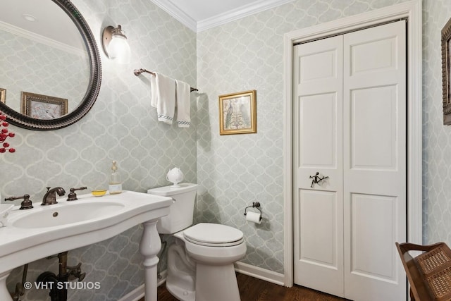 bathroom featuring crown molding, toilet, and hardwood / wood-style flooring