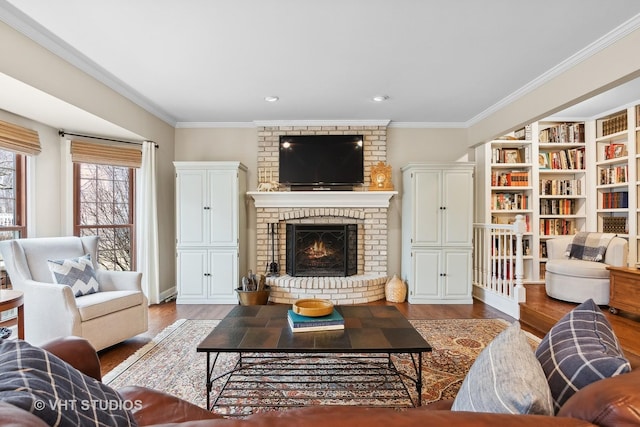 living room with crown molding, a fireplace, and light wood-type flooring