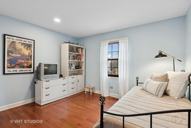 bedroom featuring dark hardwood / wood-style flooring