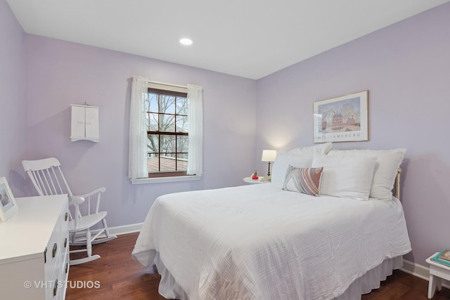 bedroom with dark hardwood / wood-style floors