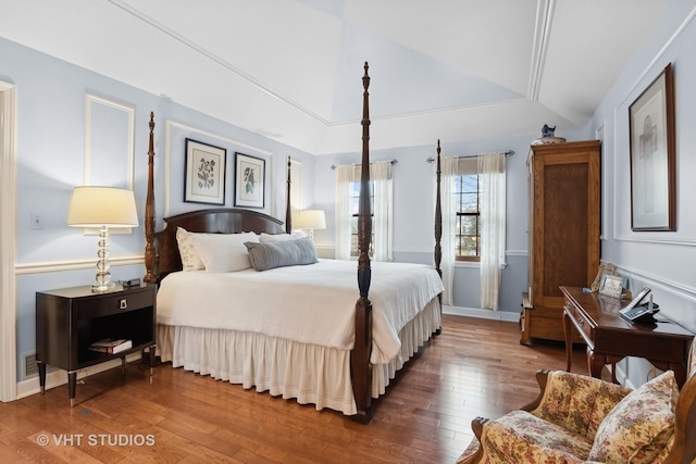 bedroom with lofted ceiling and hardwood / wood-style flooring