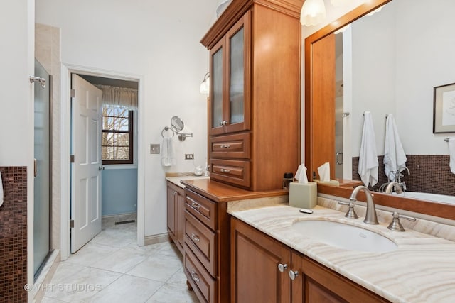 bathroom featuring vanity, tile patterned floors, and walk in shower