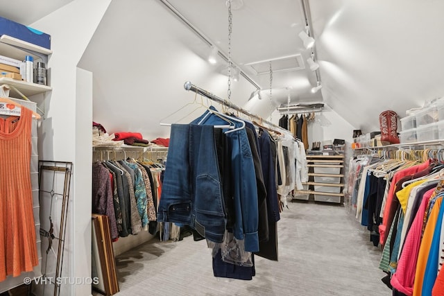 spacious closet with vaulted ceiling and light carpet